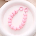 Detailed close-up of pink faceted heart bead strap with matching metal spring ring clasps - Light Pink
