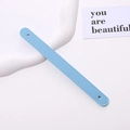 Detail view of light blue PU leather phone strap with white stitching and litchi texture - Light Blue