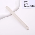 Detail of cream white lychee grain PU leather wrist strap with reinforced stitching - White