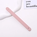 Detailed view of a pink lychee grain leather phone strap with white stitching and mounting holes - Korean Pink