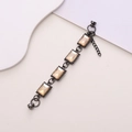 Detail view of rectangular champagne gemstones in gun-black settings with a secure clasp - Rectangular Champagne Gem (k188) / Champagne