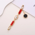 Golden bracelet with red and white glass gems and Roman numeral pendant on white background - Red Gemstone Roman Numeral Pendant (K161) / Red