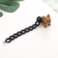 Detailed close-up of a resin French bulldog charm with thick black acrylic chain strap - Thick Chain Style / Khaki