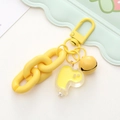 Detail of a bright yellow cartoon duck keychain with acrylic pendant and metal bell - Yellow Chain Duck