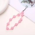 Detail of pink floral beaded phone strap with handmade wooden flower beads and wrist loop - Pink Crescent Flower