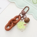 Detail of creative cartoon keychain with brown chain link, bell, and matte carabiner hook - Coffee Chain Small Tree