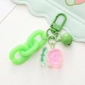 Close-up of a green acrylic chain keychain with a cute pink smiling cherry pendant - Green Chain Tulip Flower