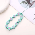 Detail of mint green wooden flower beads and pastel round charms for phone wrist strap - Green Wooden Flower