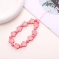 Detailed macro shot of pink wooden flower beads and round beads for a phone lanyard - Watermelon Red Wooden Flower