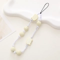 Close-up of pearl beads and cute yellow pig charms on a handmade wristlet strap - Pearlized White Cat Head Style (K1091)
