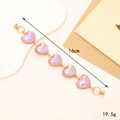 Elegant gold metal chain bracelet featuring five purple pearlescent heart pendants - Colorful Purple