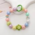 Close-up of Y2K style handmade beaded phone strap with colorful acrylic heart and flower beads - Green Cartoon Baby