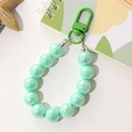 Detail of mint green iridescent beaded keychain with secure metal lobster clasp - Mermaid Beaded Pendant (K1994) / Green