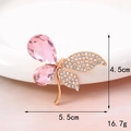 Detailed close-up of a butterfly brooch with pink crystal and gold-white rhinestone wings - Pink Maple Leaf (D020)