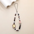 Detail of beaded phone strap featuring a yellow bear charm and heart cube bead - Black White Brown Heart Square Bear Style (K1163)
