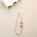 Detail of pink cracked beads and acrylic cupcake charms on a beaded phone strap - Pink Flower Crackle Bead Style (K1194)