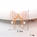 Detail of a gold bow brooch with pearls and hanging zircon tassels for DIY accessories - Artificial Pearl Bowknot (D131)