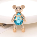 Macro shot of teddy bear crystal pendant with blue teardrop stone and gold plating - Lapis Lazuli Blue