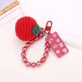Detailed shot of handmade crochet red apple keychain with pink beads and gift tag - Beaded Red Apple Style