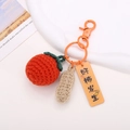 Close-up of hand-crocheted orange persimmon and peanut keychain with vivid knit texture - Persimmon And Peanut Style-Red