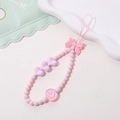 Detailed view of pink beaded phone strap with heart charms, bow, and smiley face - Phone Chain / K1830 Bowknot Phone Chain Pink