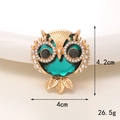 Detailed close-up of golden owl brooch with green gemstones and white rhinestones, 4.2x4cm - Gold Base Green Owl