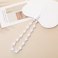 Macro detail of white star-shaped beads and round pearls on a minimalist phone strap - White (Star Bead)