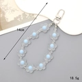 Matte acryl bloem sleutelhanger met blauwe accenten en zilveren karabijnsluiting - Blauw