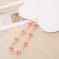 Detail shot of orange frosted flower beads and transparent pearls on a phone wrist strap - Orange (Orange Frosted Flower)