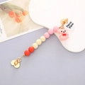 Close-up of beaded phone strap with a pink flocked bear and golden heart clasp - K526 Pink Bear Bracelet Heart Clasp (With Adhesive)