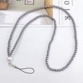 Detail of beaded mobile phone strap with metallic grey beads and a white pearl accent - Gray
