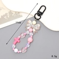 Pink beaded bunny keychain with cross pendant and iridescent bow ornament, 11cm length - Black Clasp + Pink Bow Pendant