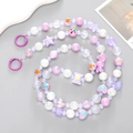 Detail of colorful acrylic beads featuring heart, star, and bow designs for phone lanyard - Purple Series