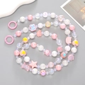 Detail view of colorful beaded mobile strap with acrylic hearts, stars and cartoon bears - Pink Series