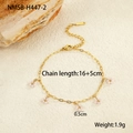 Detail view of gold beaded chain bracelet featuring five delicate white flower pendants - Pink Flower Bracelet (NMSB-H447-2) / Pink