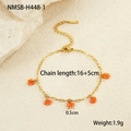 Detailed view of a gold chain bracelet with five orange beaded sunflower charms and size labels - Orange Flower Bracelet (NMSB-H448-1) / Orange