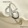 Macro detail of silver infinity symbol bracelet with mirror polished stainless steel surface - Steel Color Double Circle Infinity Style (NMSB-E438-2) / 18K Gold