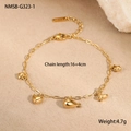 Detail of gold bracelet with whale and heart charms on warm textured background - 18K Gold / Gold Fish Style (NMSB-G323-1)