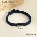 Detail shot of navy braided rope bracelet with custom black stainless steel bar and logo - 18K Gold / Deep Blue (NMSB-H522-1)