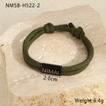Macro view of green braided paracord bracelet with 2.0cm black engraved metal charm - 18K Gold / Military Green (NMSB-H522-2)