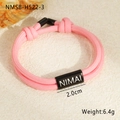 Detail of pink woven nylon rope bracelet with black engraved metal plate and seashell decoration - 18K Gold / Pink (NMSB-H522-3)