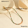 Detailed view of bohemian beaded necklace with natural stones on a ceramic tray - Dark Green and Orange Vibrant Beads with Metal Small Tag Style (NMSN-H525-2)