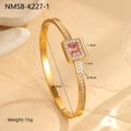 Detailed macro of gold plated bangle featuring emerald-cut pink zircon and pavé setting - Square Pink Diamond Bangle (NMSB-K227-1)