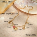 Golden ocean theme necklace with starfish and shell charms displayed on a beach scene - Shell Red Heart Necklace (NMSN-K456-5)