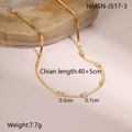 Detailed macro view of a gold-plated snake chain necklace with five rectangular zircon accents - 18K / Gold White Zirconia