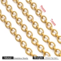 Macro detail of 18k gold plated stainless steel twisted and smooth oval link chain - Gold