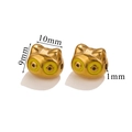 Macro view of gold-plated cat-shaped metal beads with enamel eyes for DIY jewelry - Yellow Cat