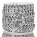 Macro detail of silver shell-shaped stainless steel DIY jewelry chain on a white spool - Steel