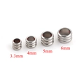 Detailed view of stainless steel spacer beads with grooved texture in four sizes - 3.3mm / Steel