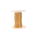 Macro view of 0.25mm gold plated stainless steel thin chain on a white plastic spool - Fine Cross Chain / Gold
